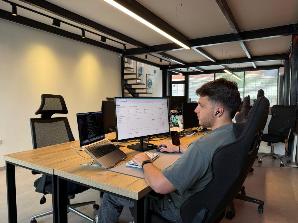 A Sigma Technology colleague, sitting at a desk, working on the Ettanfotboll platform
